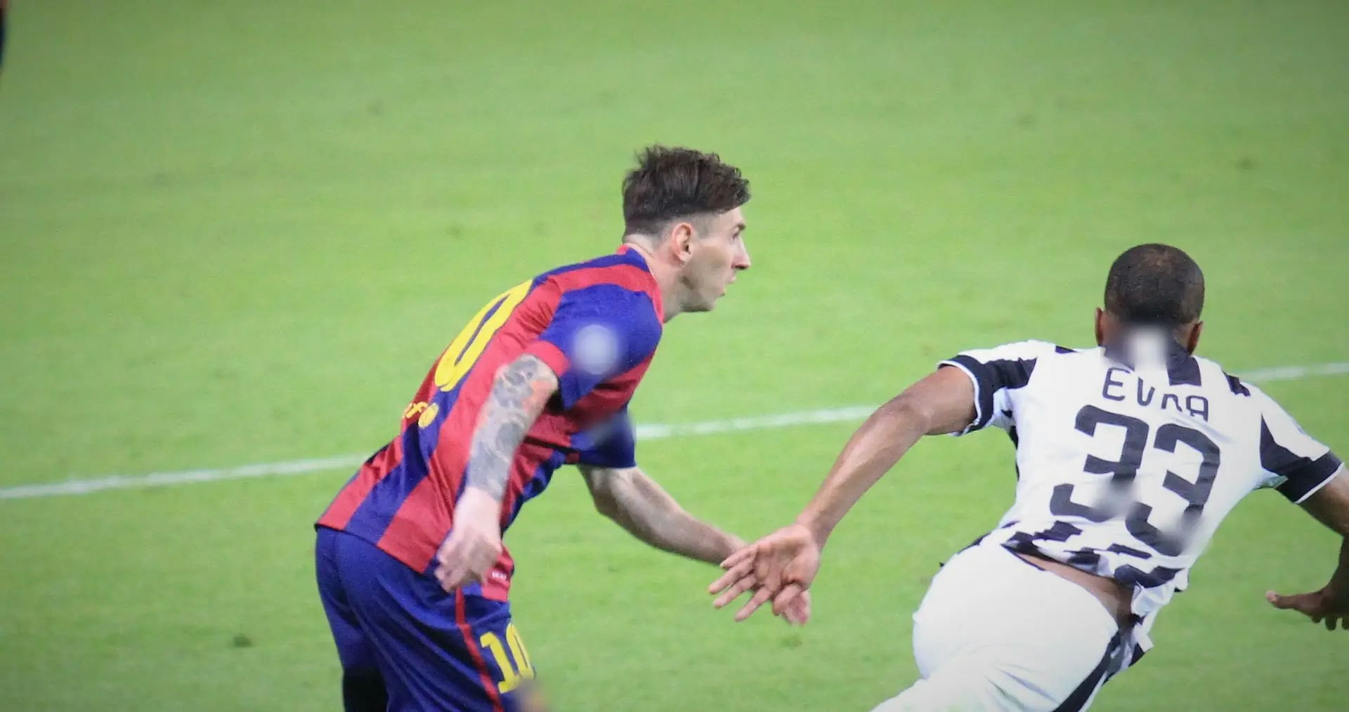 Messi in Barcelona colours chasing alongside a Juventus player with EVRA 33 on his shirt, on open green. 2015 Champions League final, Berlin. Marks blurred in the film.