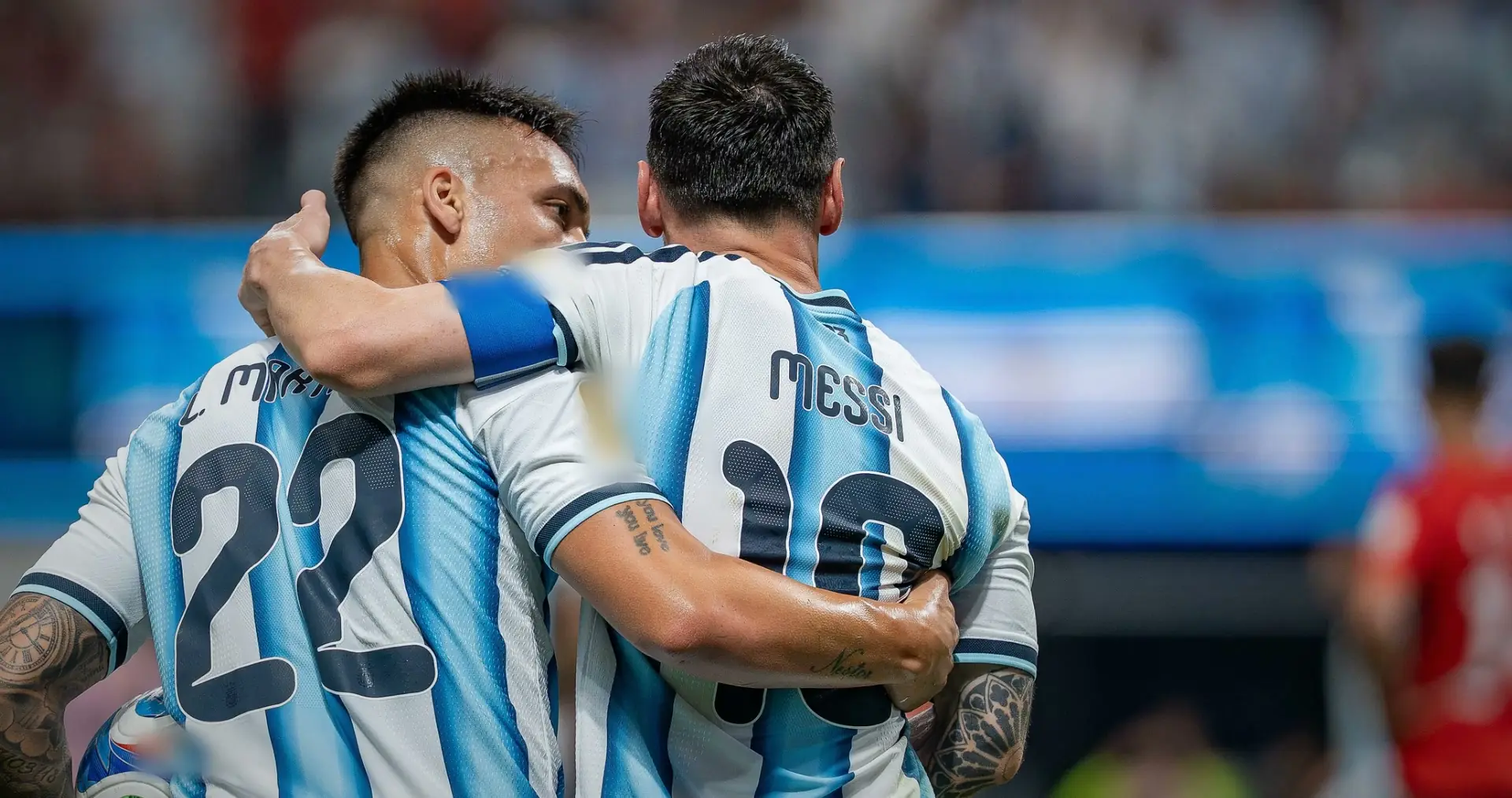 Lautaro Martinez with his arm around Messi, both seen from behind in Argentina stripes. Argentina v Egypt, 7 July 2026.